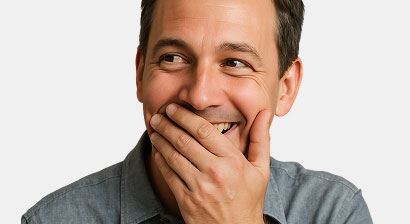 middle age man smiling and partially covering his mouth